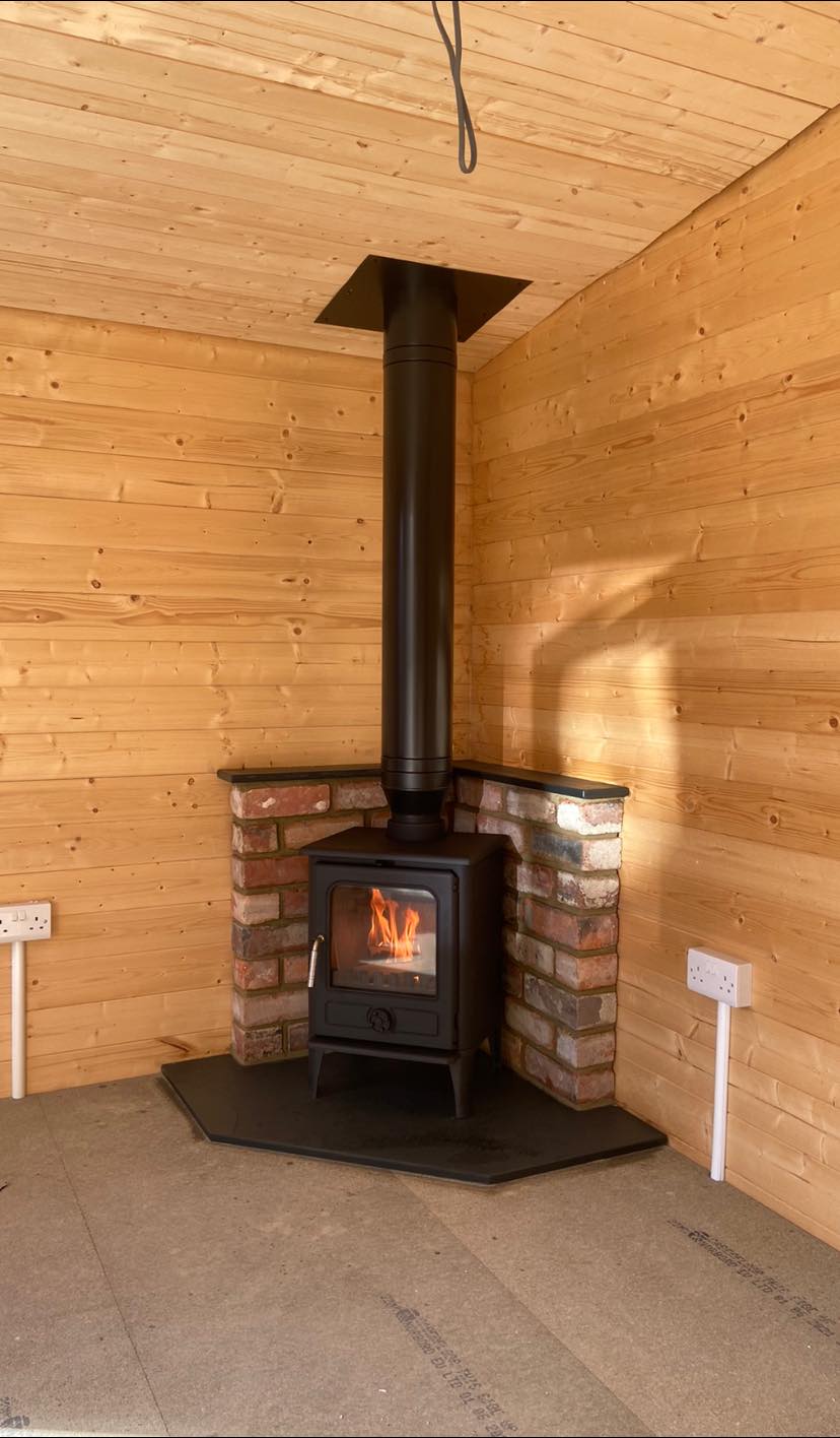 Summerhouse Stove Installation with Reclaimed Brick Heat Shield view 6